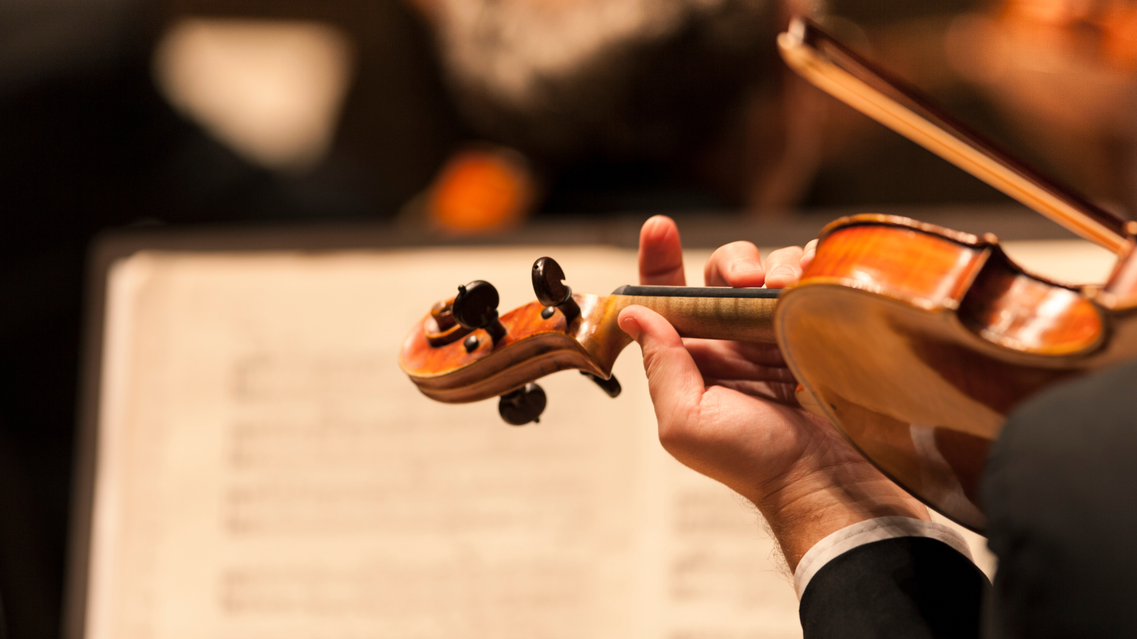 Photo of a violin and sheet music in reference to a story in the article titled Navigating U.S. Immigration Addressing Fears and Missed Opportunities